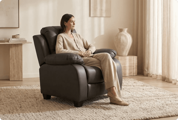 Woman sitting in a recliner chair in a cozy living room.