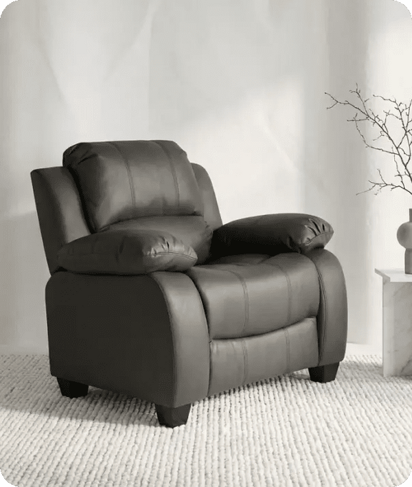 Gray recliner chair in a room with a neutral background