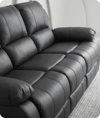 Gray leather recliner sofa in a living room setting