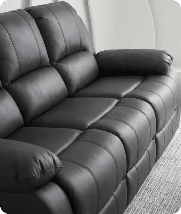 Gray leather recliner sofa in a living room setting