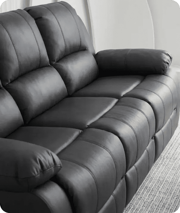 Gray leather recliner sofa in a living room setting