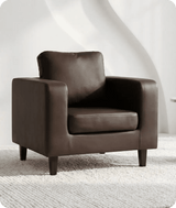 Brown leather armchair on a textured white floor with a white wall background