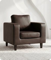 Brown leather armchair on a textured white floor with a white wall background