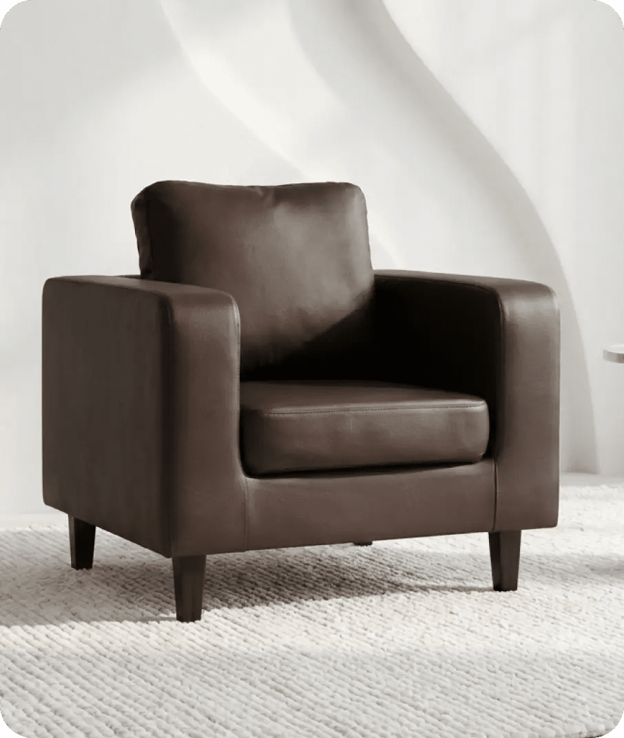 Brown leather armchair on a textured white floor with a white wall background