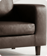 Brown leather armchair on a white background