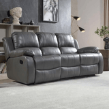 Gray reclining sofa in a living room setting with decor elements.