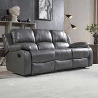 Gray reclining sofa in a living room setting with decor elements.