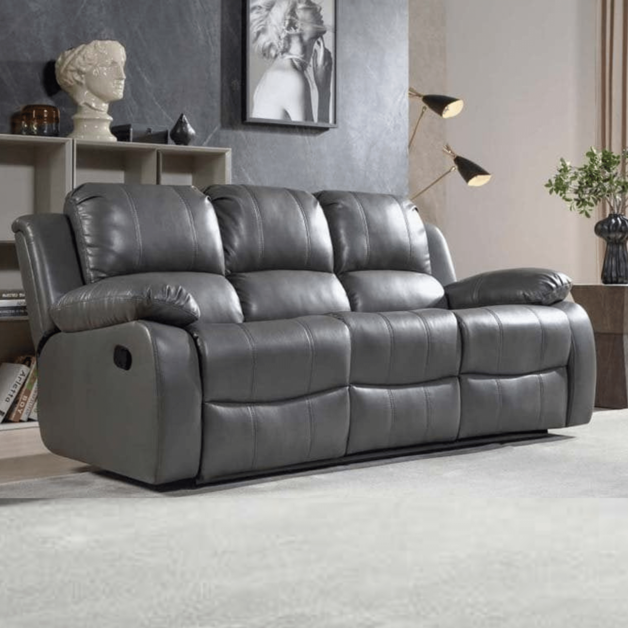 Gray reclining sofa in a living room setting with decor elements.