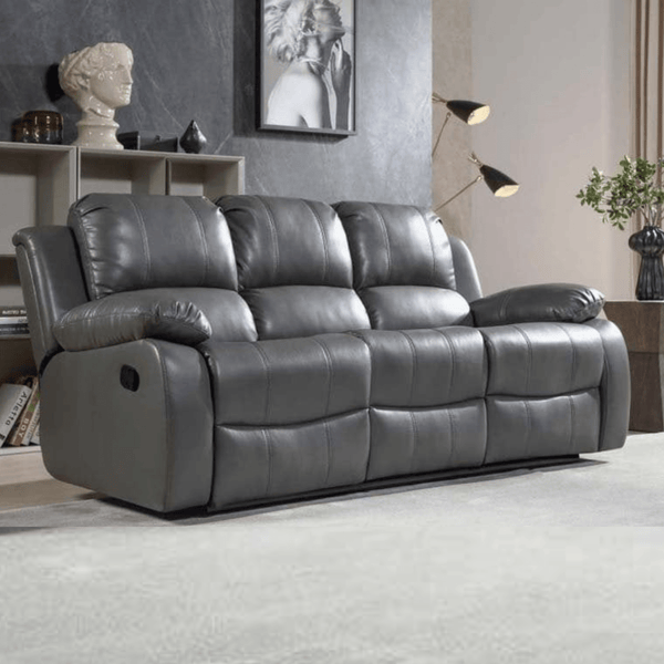 Gray reclining sofa in a living room setting with decor elements.